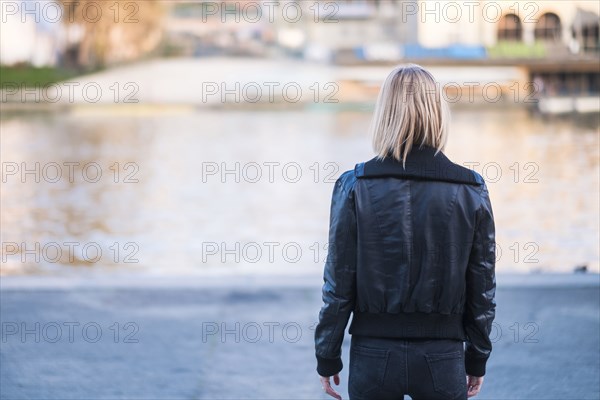 Rear view of Caucasian woman standing near river