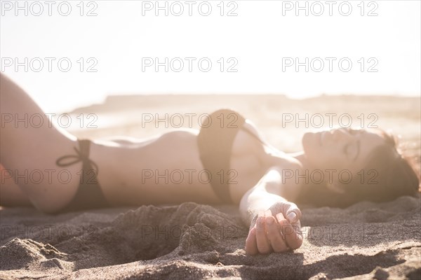 Caucasian woman sunbathing on beach