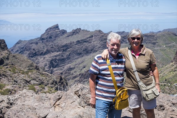 Portrait of smiling older Caucasian couple on mountain