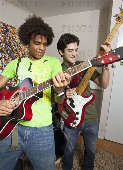 Friends playing guitar together