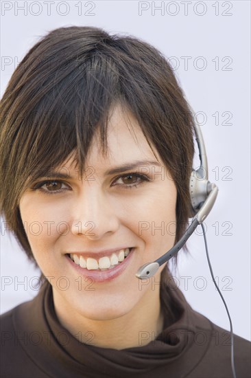 Hispanic businesswoman wearing headset