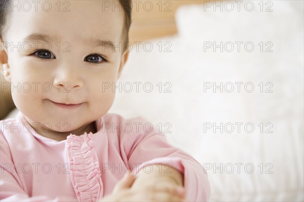 Smiling Hispanic baby girl