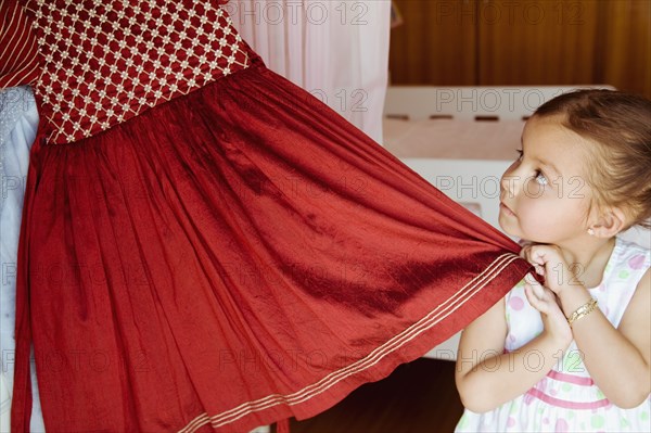 Hispanic girl taking costume from closet