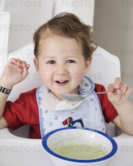 Hispanic boy eating cereal