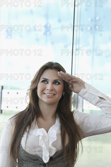 Hispanic businesswoman saluting