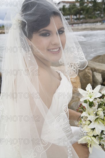 Hispanic bride in wedding dress