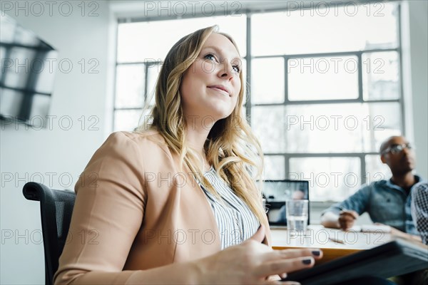 Businesswoman listening in meeting