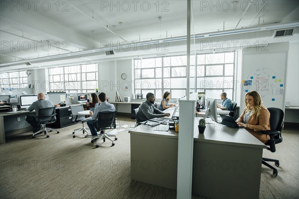 Business people working in busy office