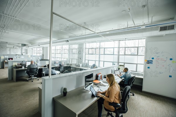 Business people working in busy office