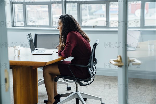 Mixed race businesswoman on video conference