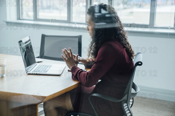 Mixed race businesswoman on video conference