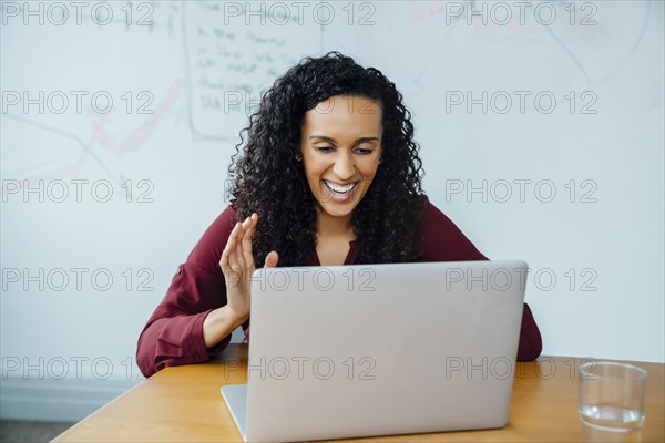 Mixed race businesswoman on video conference