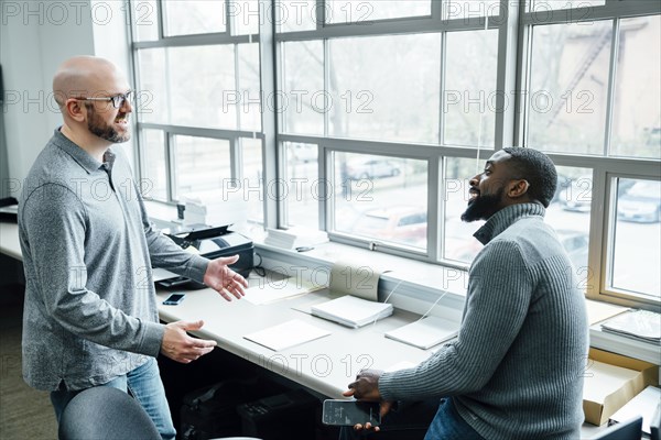 Businessmen talking in office