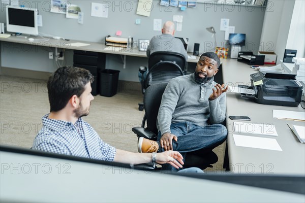 Businessmen talking in office