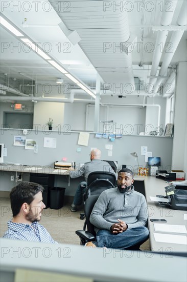 Businessmen talking in office