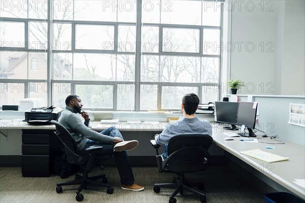 Businessmen talking in office