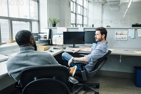 Businessmen talking in office