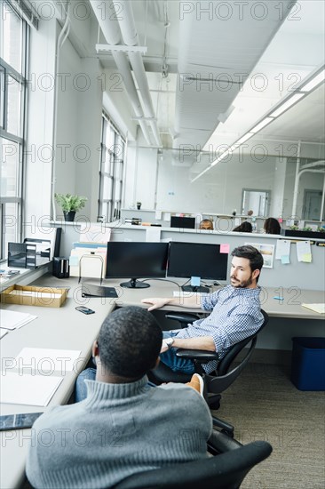 Businessmen talking in office