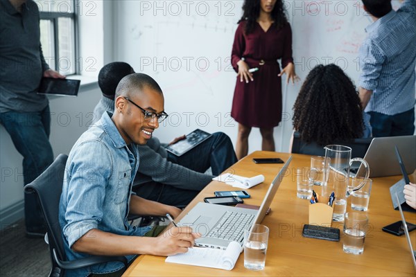 Businessman writing notes in meeting