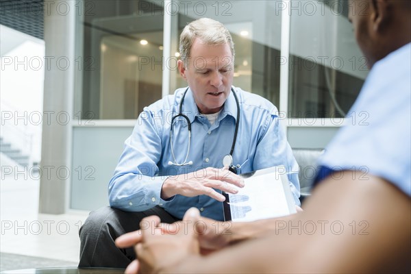 Doctor and nurse discussing digital tablet