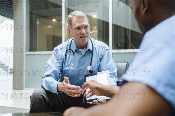 Doctor and nurse discussing digital tablet