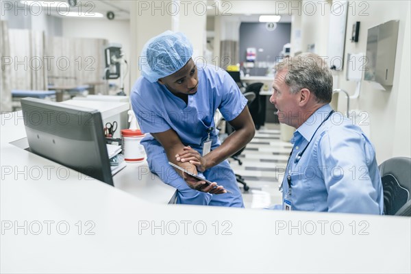 Doctor and nurse discussing digital tablet