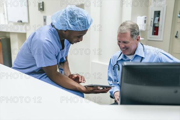 Doctor and nurse discussing digital tablet