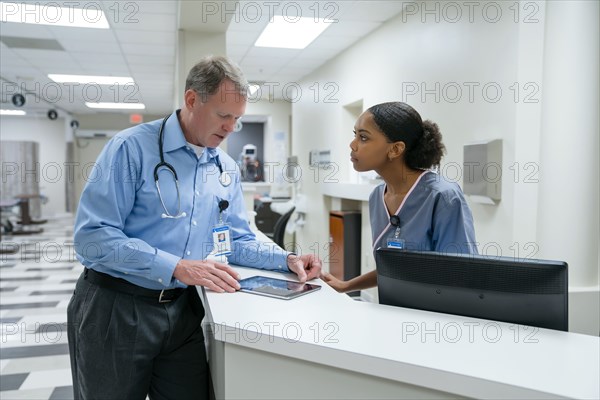 Doctor and nurse using digital tablet