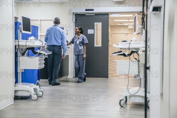 Doctor and nurse talking in hospital