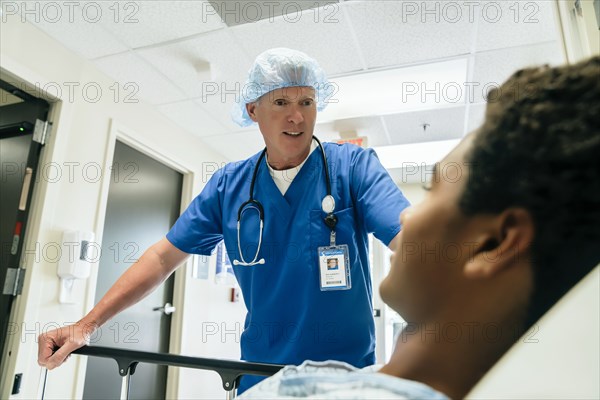 Nurse talking to boy in hospital bed