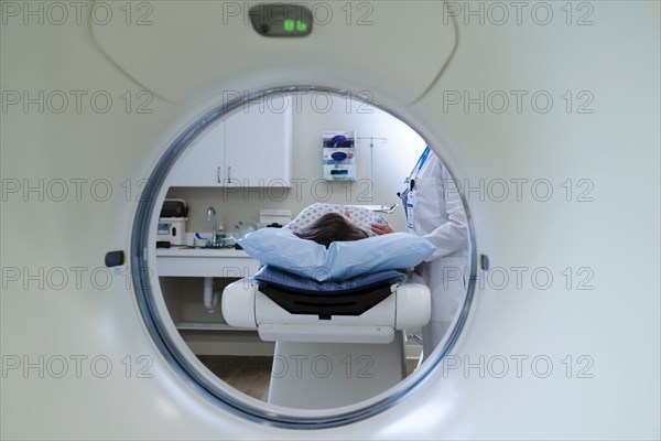 Caucasian doctor comforting patient near scanner