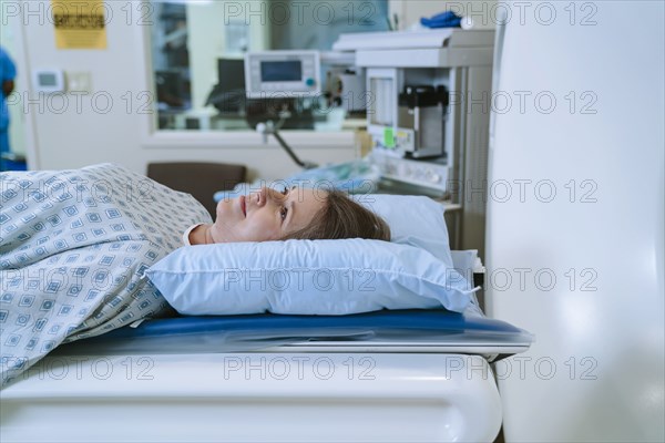 Caucasian woman laying on scanner table