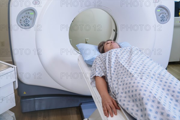 Caucasian patient laying on scanner table