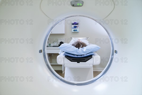 Caucasian patient laying on scanner table