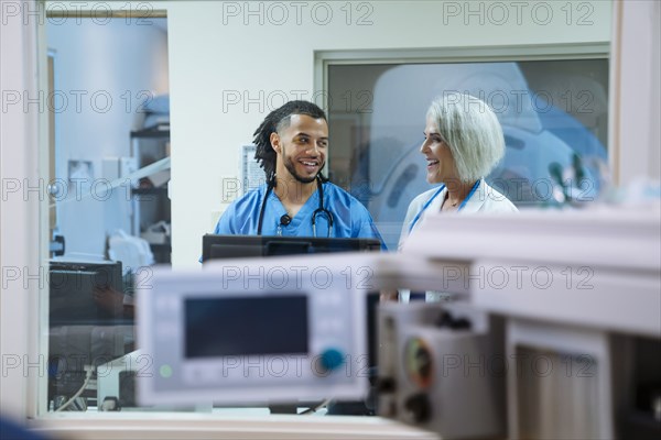 Smiling doctor and nurse talking