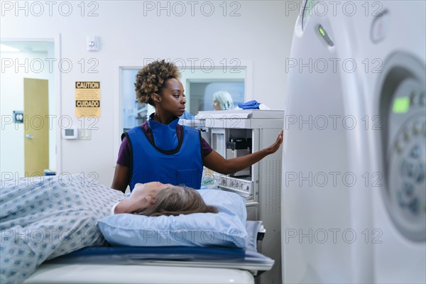 Technician preparing scanner for patient