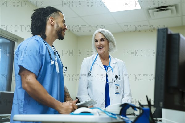 Smiling doctor and nurse talking