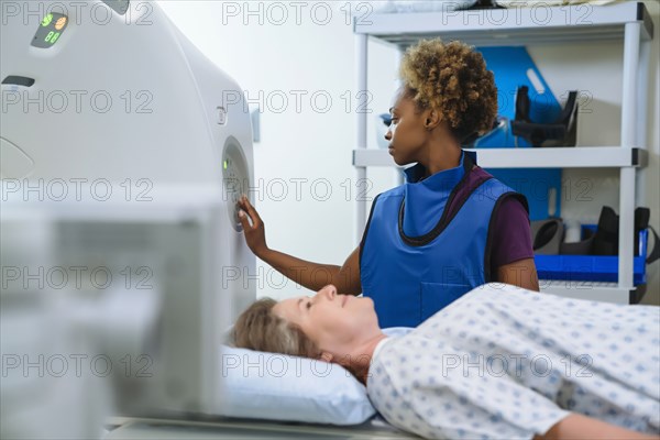 Technician preparing scanner for patient