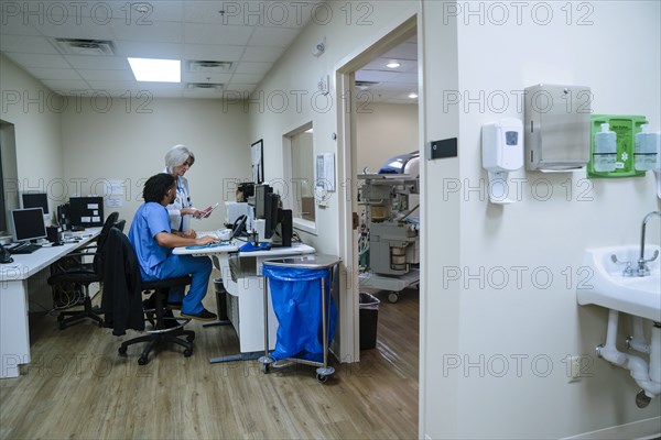 Doctor and nurse discussing digital tablet