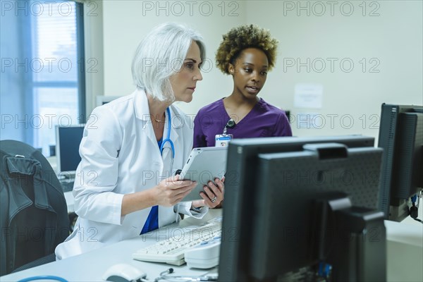 Doctor and nurse using digital tablet and computer
