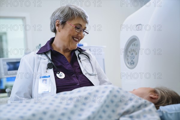 Doctor talking to patient at scanner