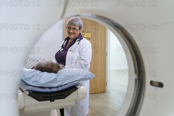 Doctor talking to patient at scanner