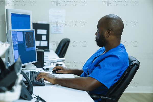 Black nurse using computer