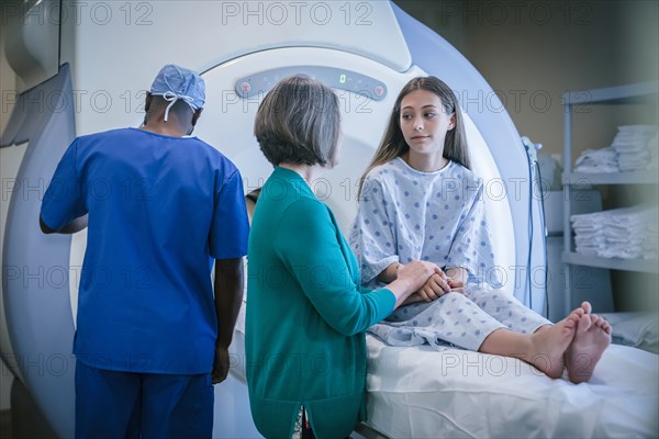 Doctor comforting patient at scanner