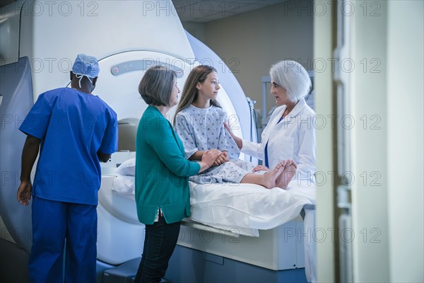 Doctor comforting patient at scanner