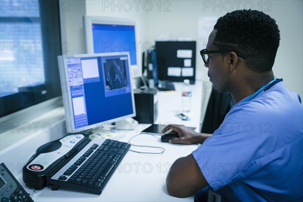 Black nurse using computer