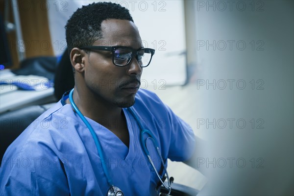 Black nurse using computer