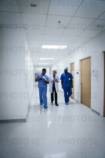 Doctor and nurses discussing paperwork in hospital