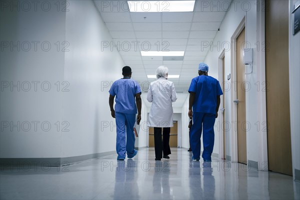 Doctor and nurses walking in hospital