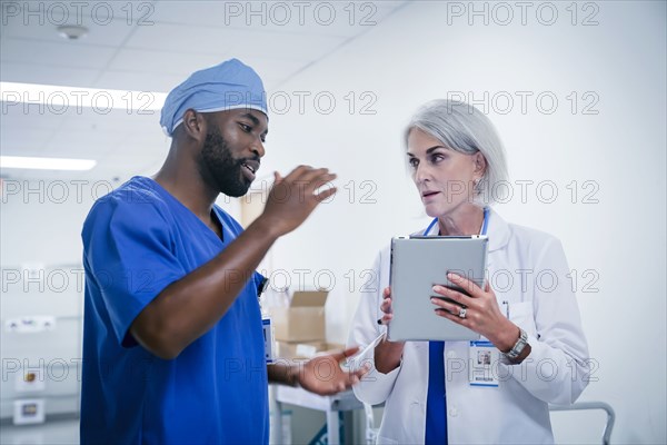 Doctor and nurse discussing digital tablet